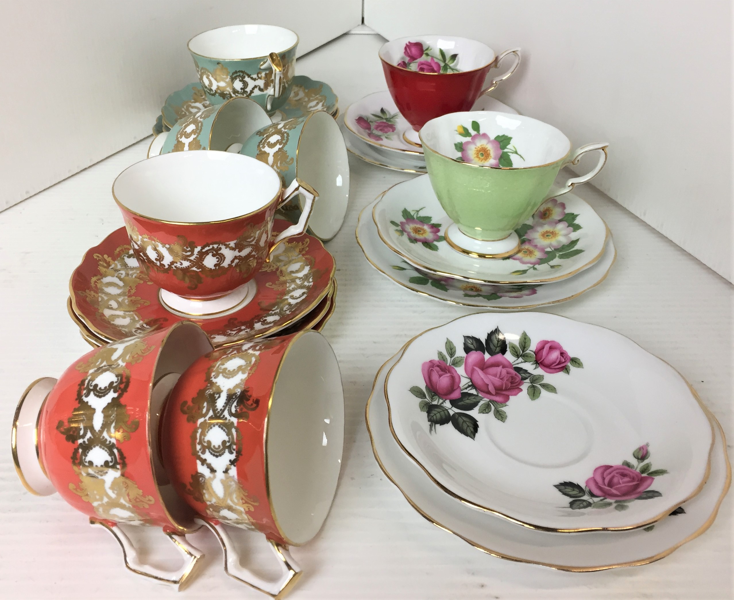 Fourteen items including six Aynsley gilt trimmed cups and saucers - three green and three salmon