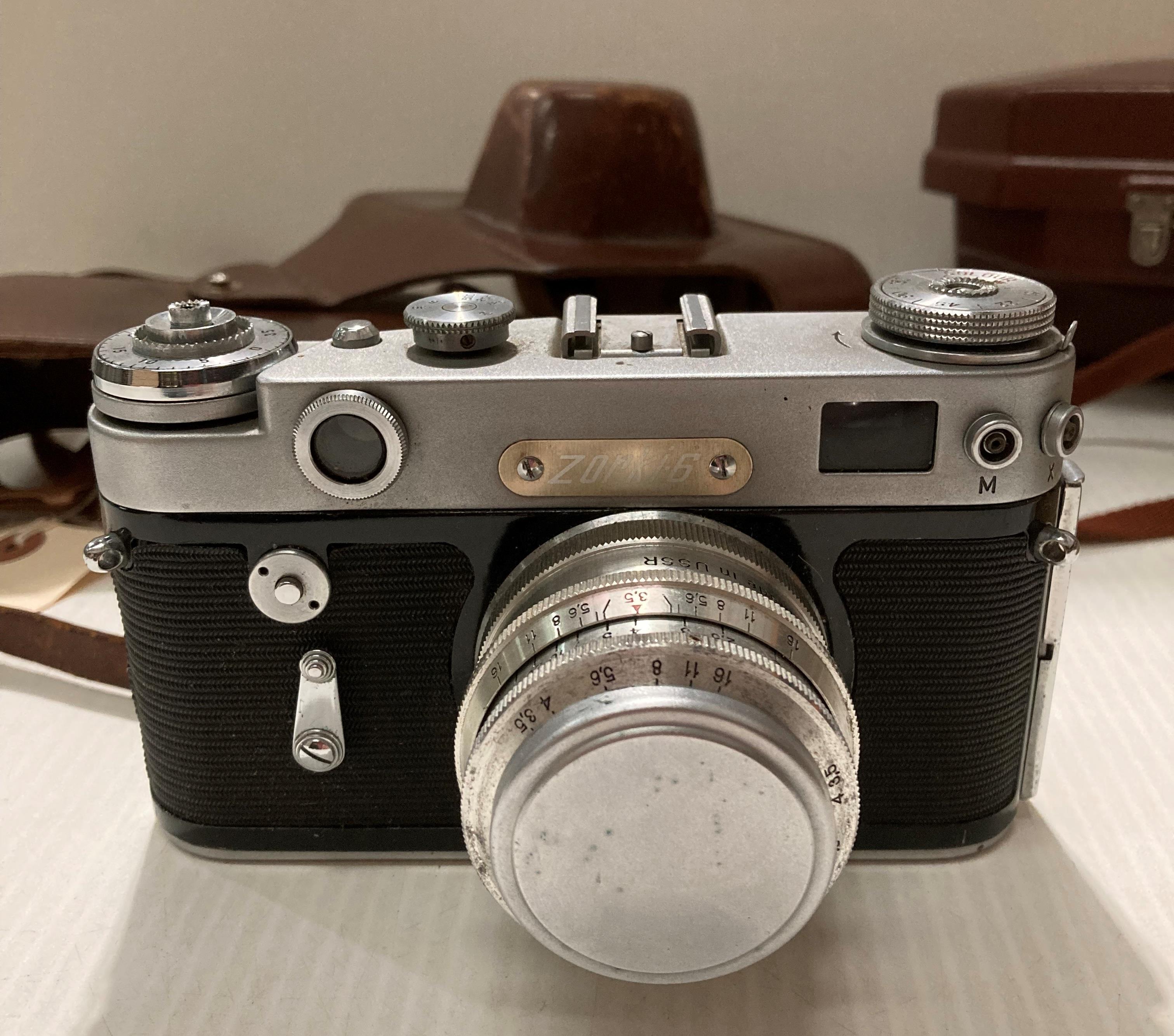 A Kodak Spool camera model 300m reflex F 1.6 in case, a 'Bolco' condenser lens and a Zorki 6 F 3. - Image 7 of 10