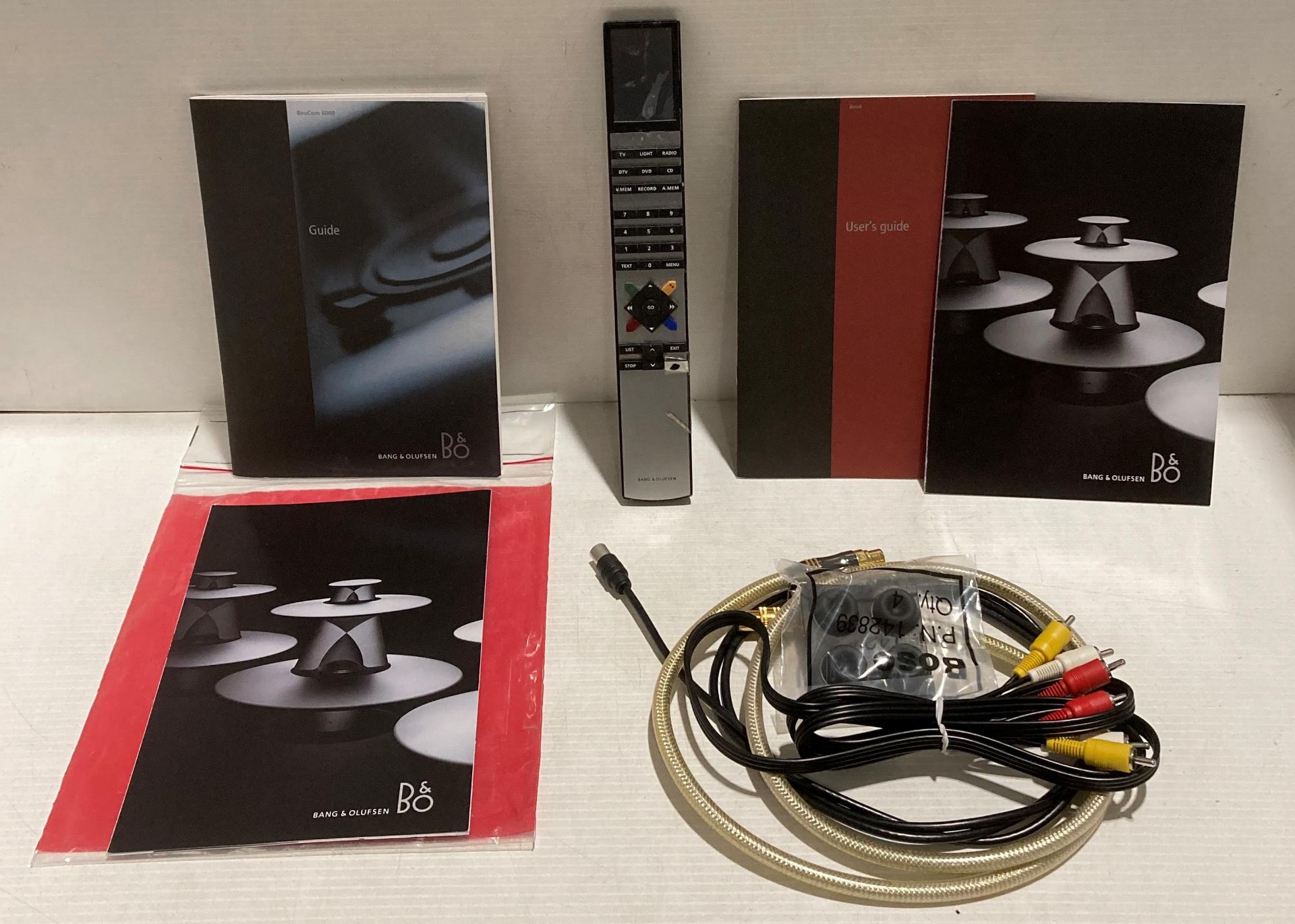 Bang & Olufsen remote control (cracked) together with leads and manuals (Saleroom location: S2)