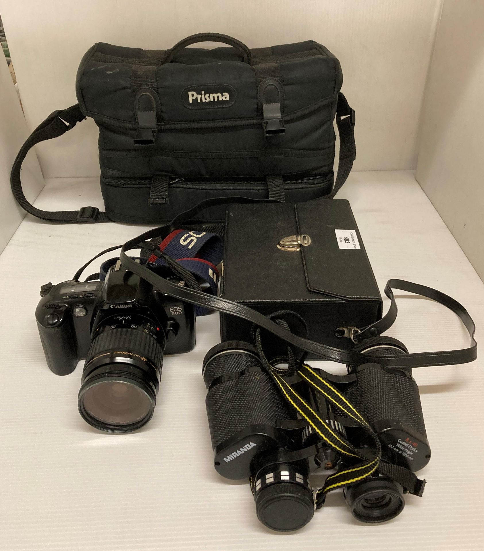 Canon E05 500 camera with a Canon ultrasonic 28-80mm lens in a Prisma bag and a pair of Miranda