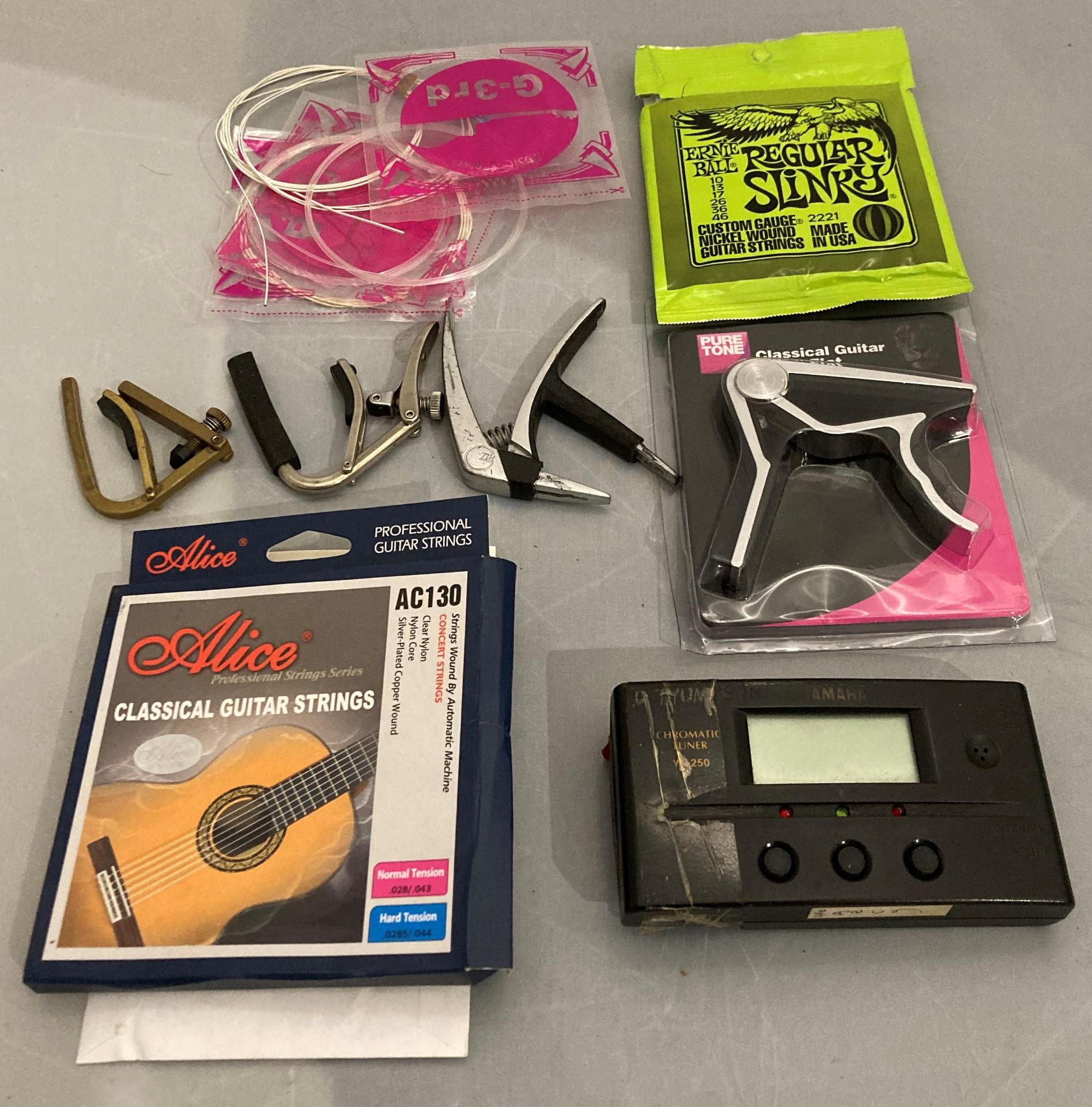 Contents to bag - sixteen assorted guitar strings by Ernie Ball and Alice AC130 etc and four