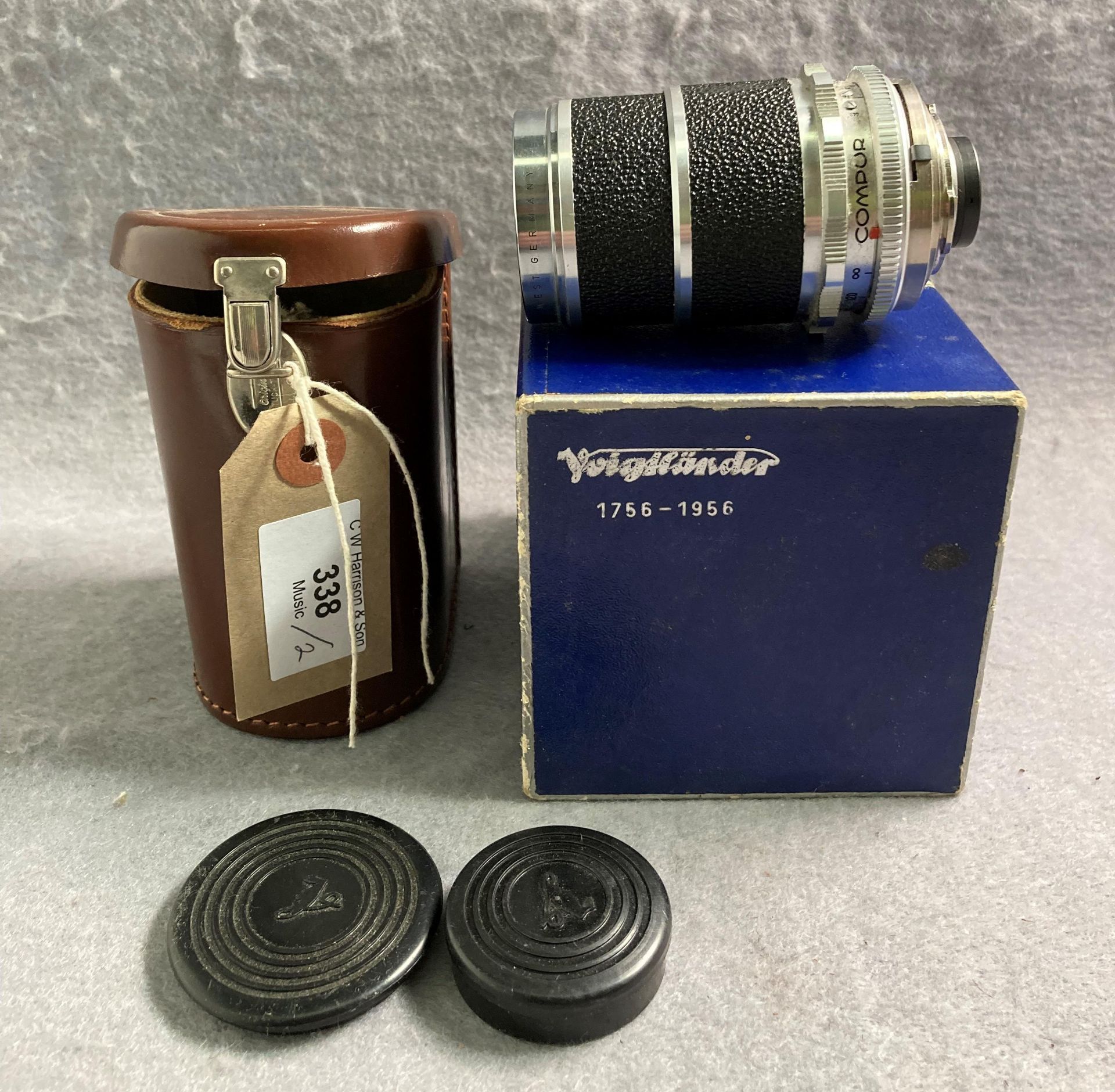 A Voigtlander Super-Dynarex 1:4/135 lens No: 5057836 in brown leather case and a Voigtlander blue