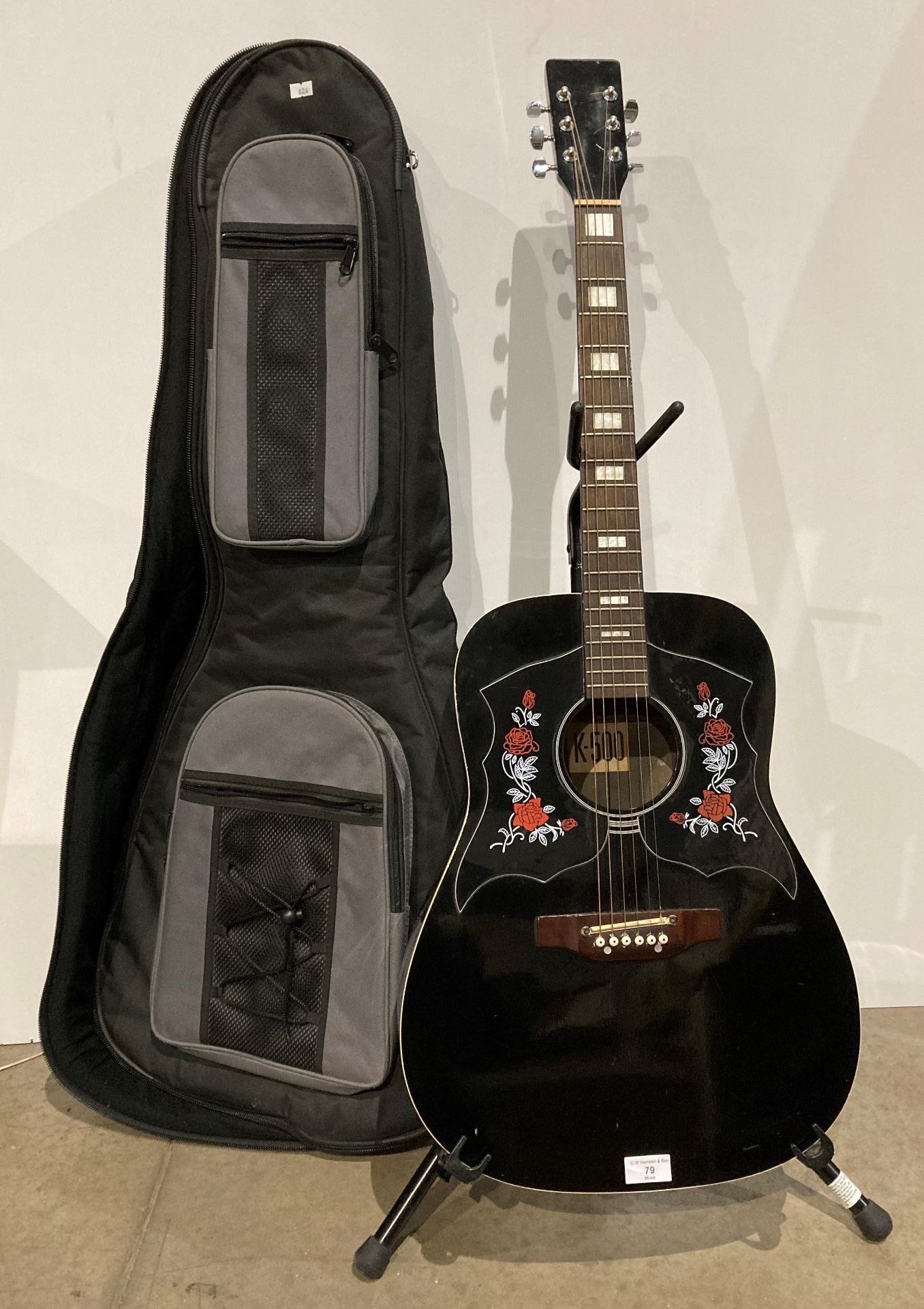 K-500 acoustic guitar in gloss black with rose pattern in a black and grey carrying bag (Saleroom