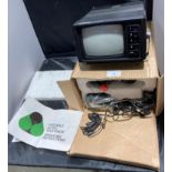 An Auritone 5" AC/DC portable television with cables and manual (no test)