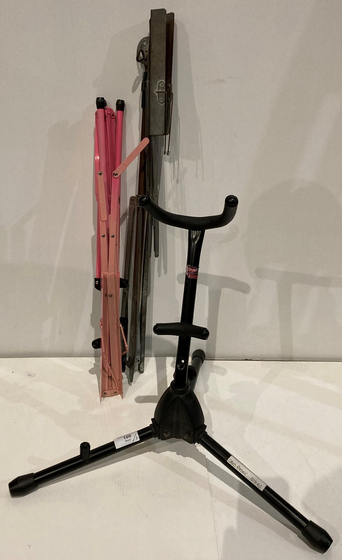 Saxophone stand and two assorted music sheet stands (Saleroom location: S3)