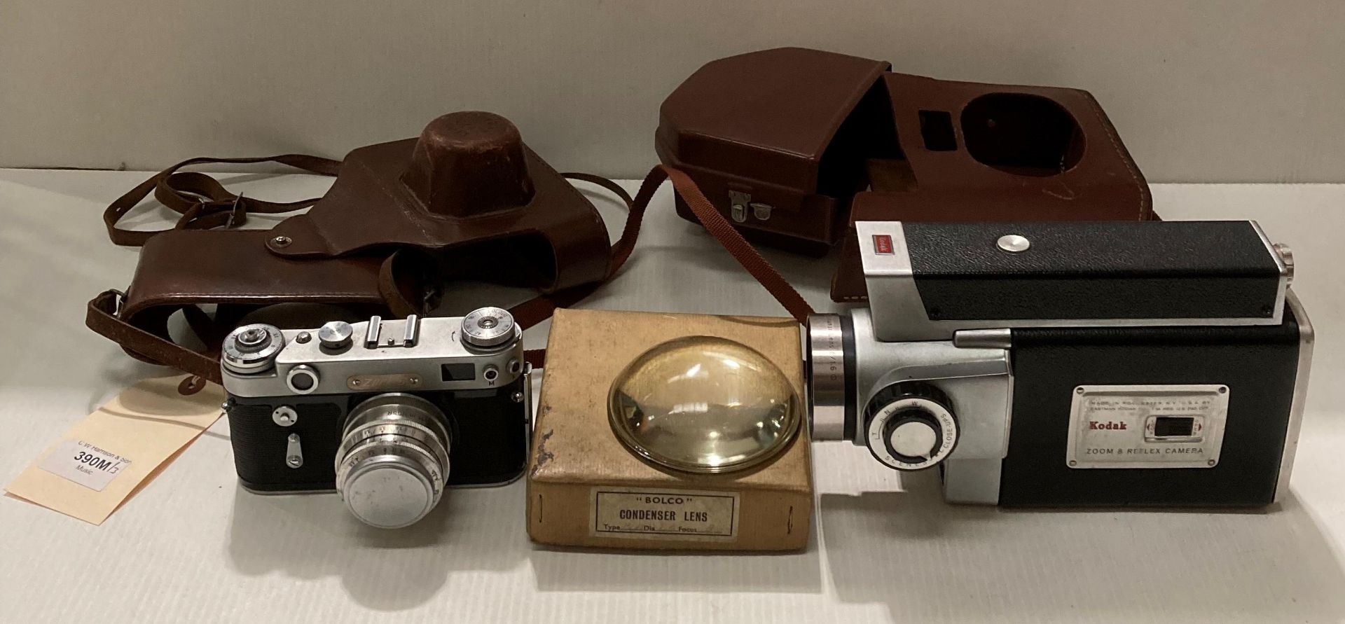 A Kodak Spool camera model 300m reflex F 1.6 in case, a 'Bolco' condenser lens and a Zorki 6 F 3.