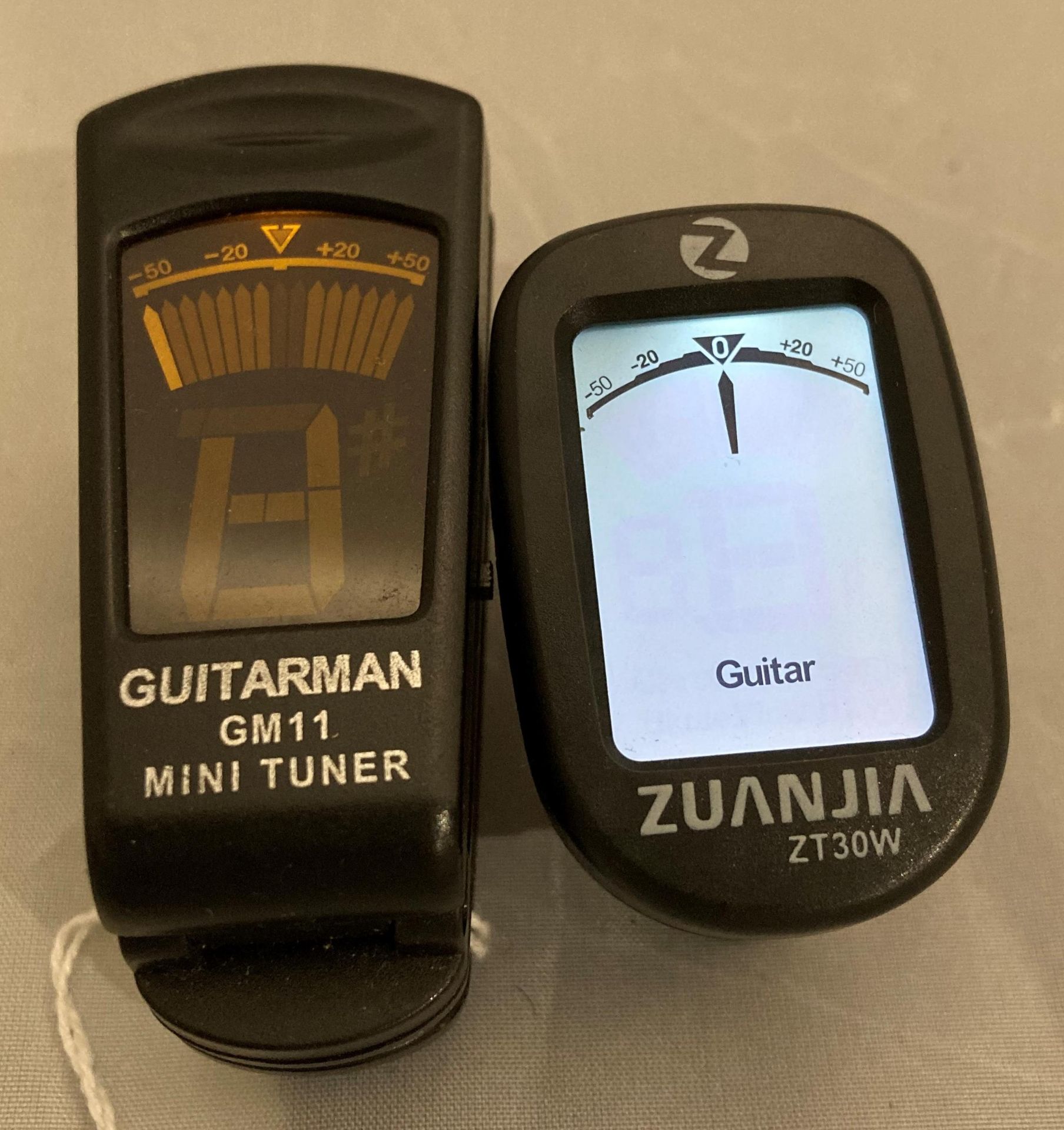 Two assorted guitar tuners by Guitarman GM11 and Zuanjia ZT30W (Saleroom location: S3)