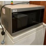 A Sharp YC-MG514-5 microwave oven (saleroom location: P0)