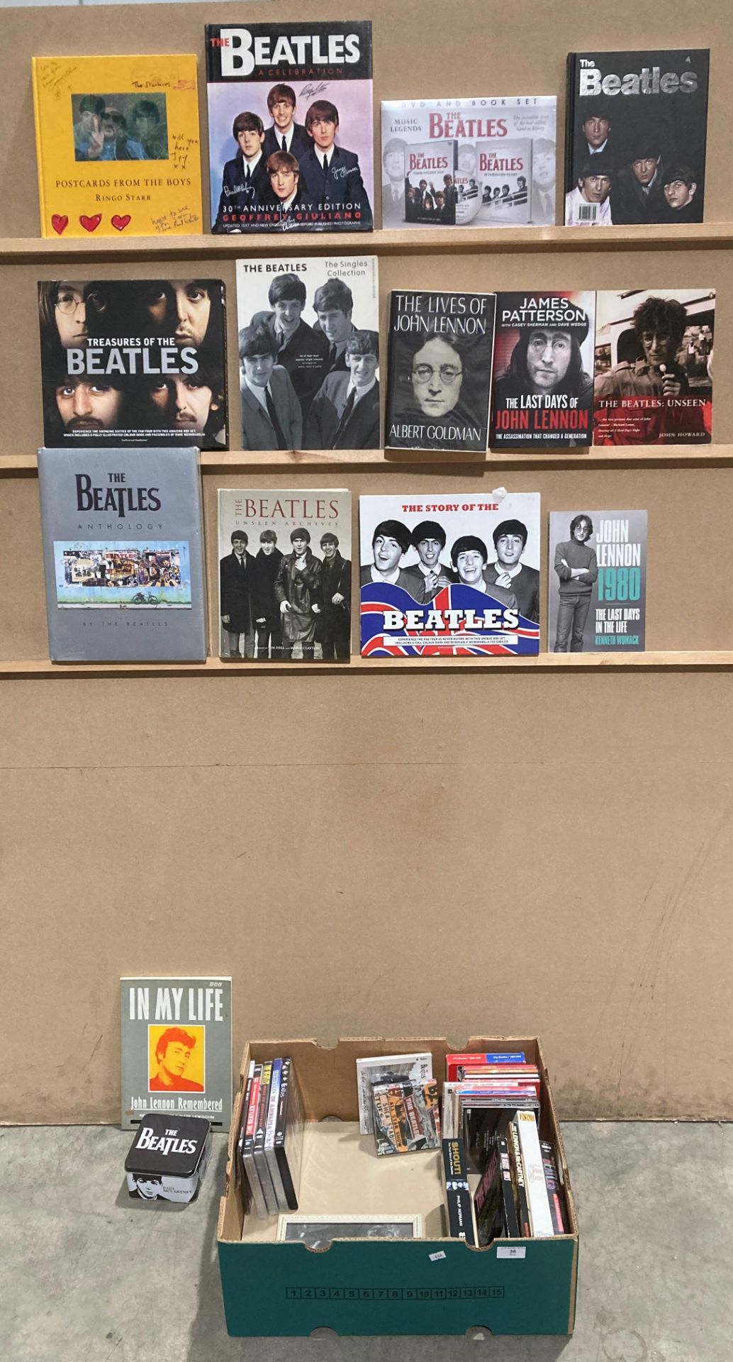 A box containing a number of books relating to The Beatles including The Beatles Anthology,