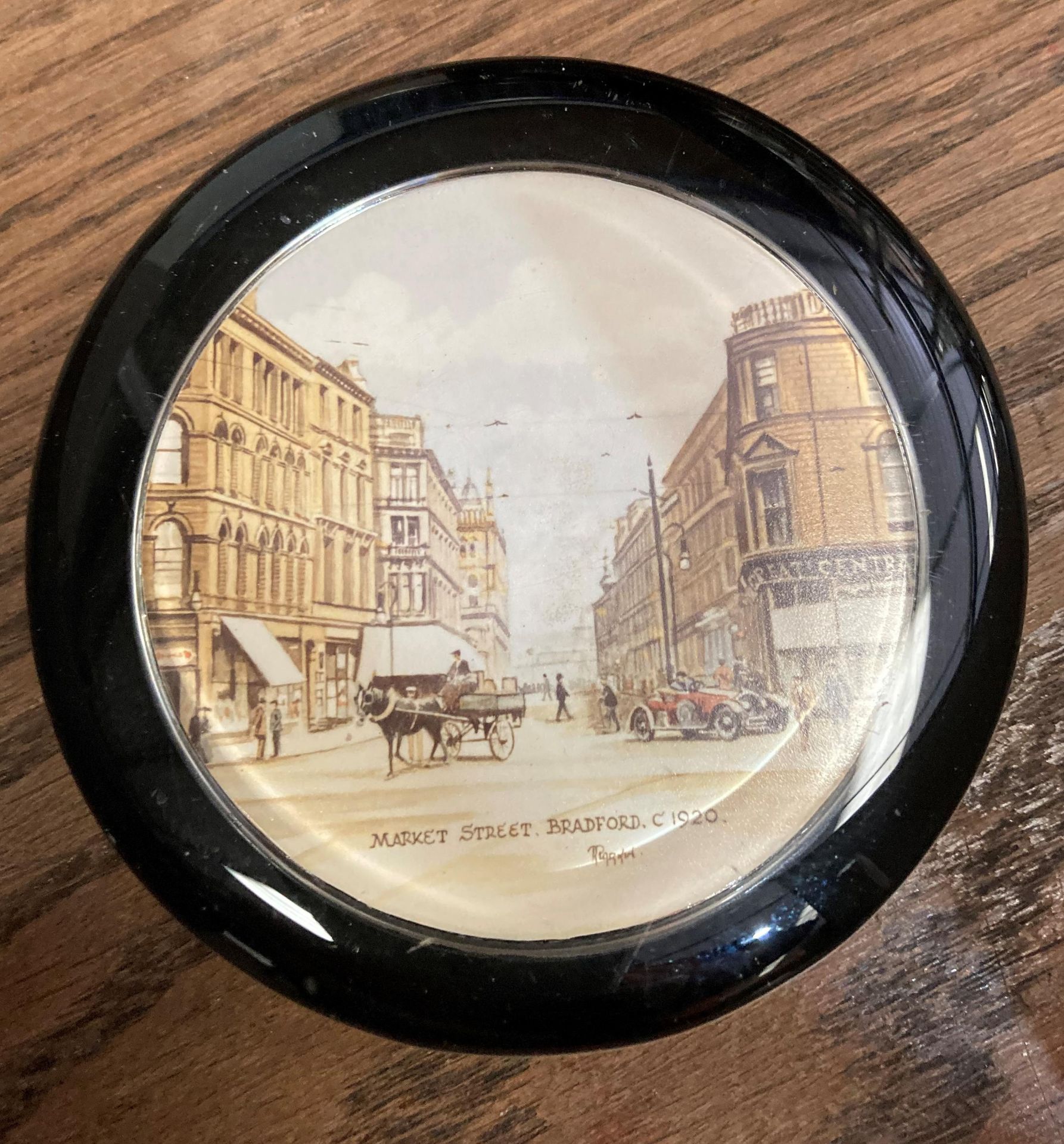 A paperweight depicting Market Street, Bradford circa 1920.