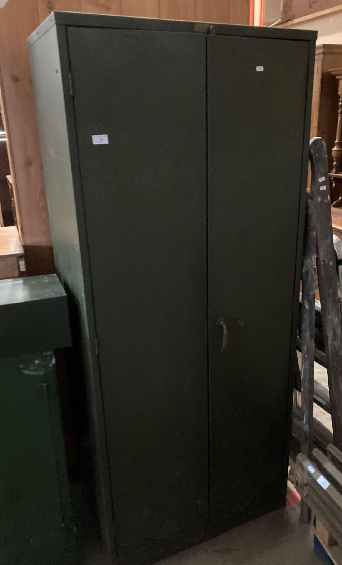 A green metal two door works cabinet,