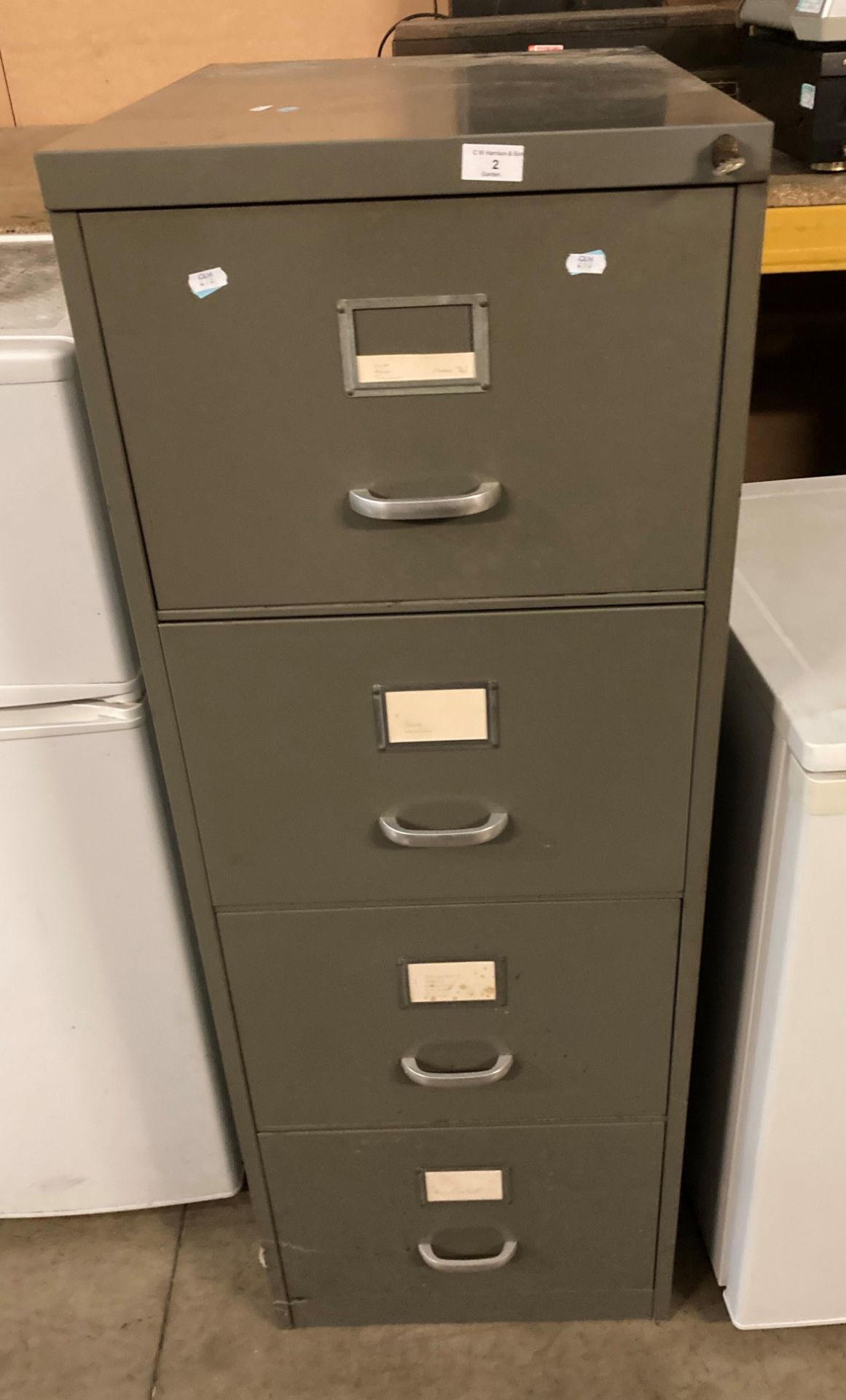 Grey metal four drawer filing cabinet complete with key (saleroom location P0)