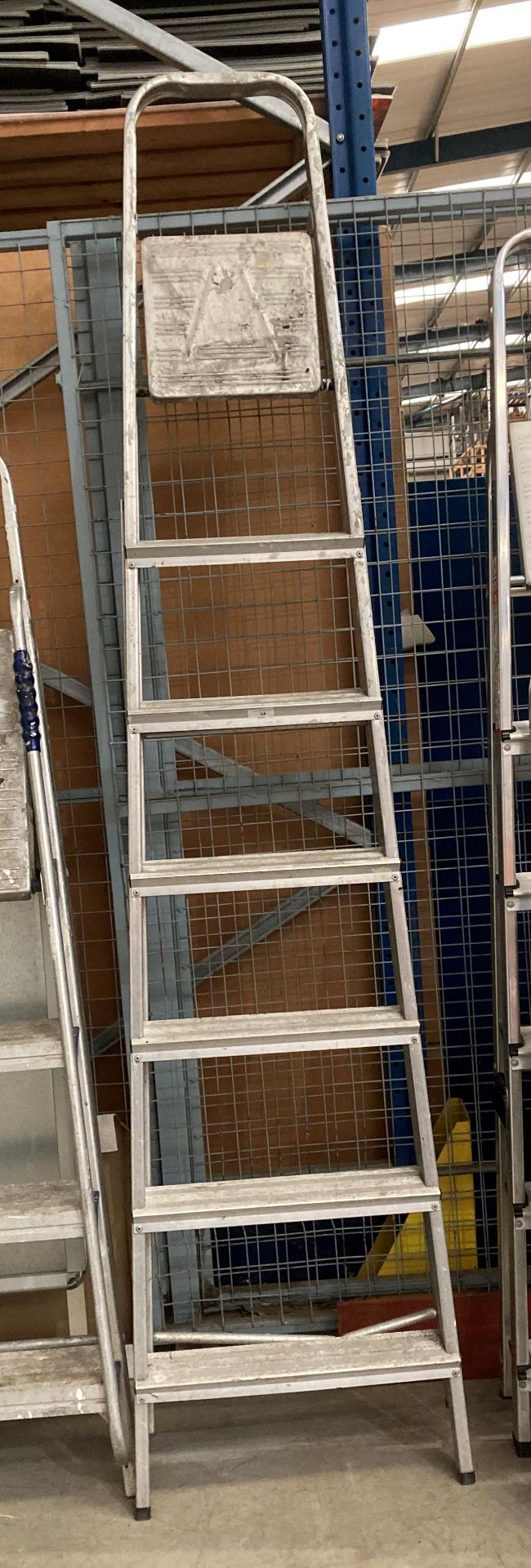 An aluminium seven-step step ladder - bottom rail bent (saleroom location: RD2)