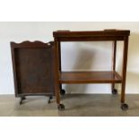 A walnut finish two tier serving trolley, the swivel top opening to reveal a green baize card table,