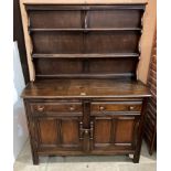 Dark stained Ercol sideboard with two tier plate rack over a two drawer, two door base,