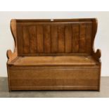 Albert Oldroyd of Cawthorne, an oak settle with high back and lift up seat storage compartment,