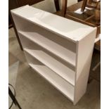 A white laminate open front bookcase,