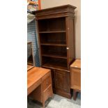 A modern mahogany finish bookcase/wall unit with four shelves over two door base,