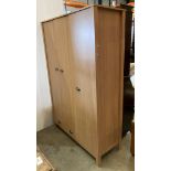A Marlow light oak finish three door, one drawer wardrobe with four shelf section to right,