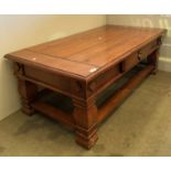 A large wooden single drawer coffee table,