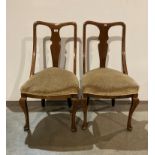 Two mahogany dining chairs with cabriole front legs with mustard-coloured upholstery (Saleroom