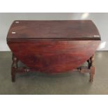 A dark stained mahogany small drop leaf spin top oval side table,