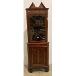 A 19th century marquetry corner cabinet in mahogany with single glazed door to top section and