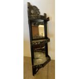A black painted mirror back corner shelf unit in oriental style,