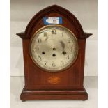 Mahogany finish mantel clock with circular face, no hands or pendulum,