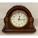 Mahogany small eight-day mantel clock with walnut inlay and brass feet, no back,