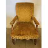 A 19th century mahogany armchair upholstered in gold floral material,