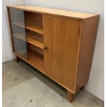 Light oak bookcase/cupboard with sliding glass doors to bookcase section and single cupboard to