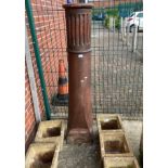 A tall salt-glazed chimney pot,