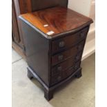 A small walnut serpentine-front four drawer chest of drawers,