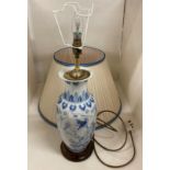 A blue oriental patterned table lamp with cream shade,