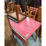 Red formica topped kitchen table with folding flap to one end, stool,