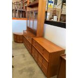 A suite of Nathan mid-century teak furniture comprising a four drawer, two door sideboard,