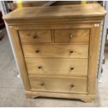 A light oak six drawer (two short, four long) chest of drawers,