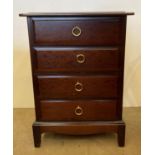 A Stag four drawer bedside cabinet in dark mahogany,