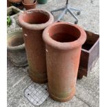 A pair of terracotta chimney pots,