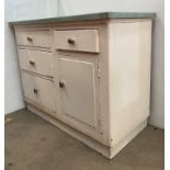 White painted pine kitchen unit with light green eggshell formica top over three graduated drawers