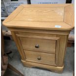 A light oak two drawer bedside cabinet - paint splattered to top (saleroom location: SBPOE)