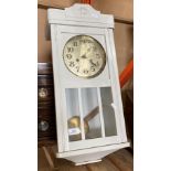 A white-painted wood wall clock,