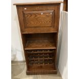 Oak fall front drinks cabinet with shelf and three tier wine rack below,