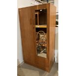 Mid-century light oak two door wardrobe, one door mirrored,