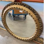 A gilt framed circular wall mirror,