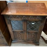 An Old Charm oak two door side cabinet with upper leaded glazed doors,