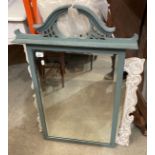 A turquoise-painted wood wall mirror,