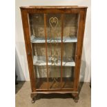 Walnut finish glass china cabinet on cabriole legs with carved front,