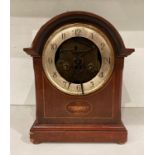 Mahogany finish mantel clock with circular face, missing glass, with single hammer chime,